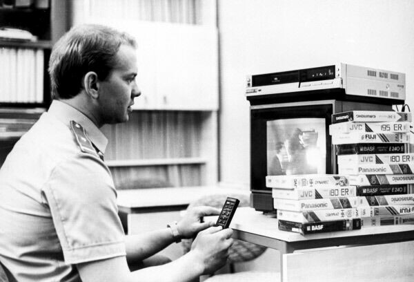 Customs officer watching video cassettes, 90s - Customs, Videotapes, 90th